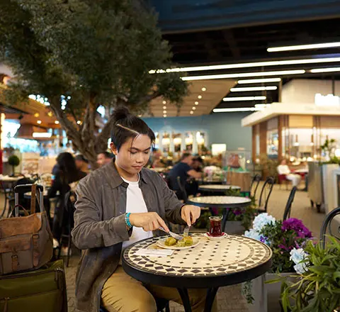 a passenger eating her food at the istanbul airport