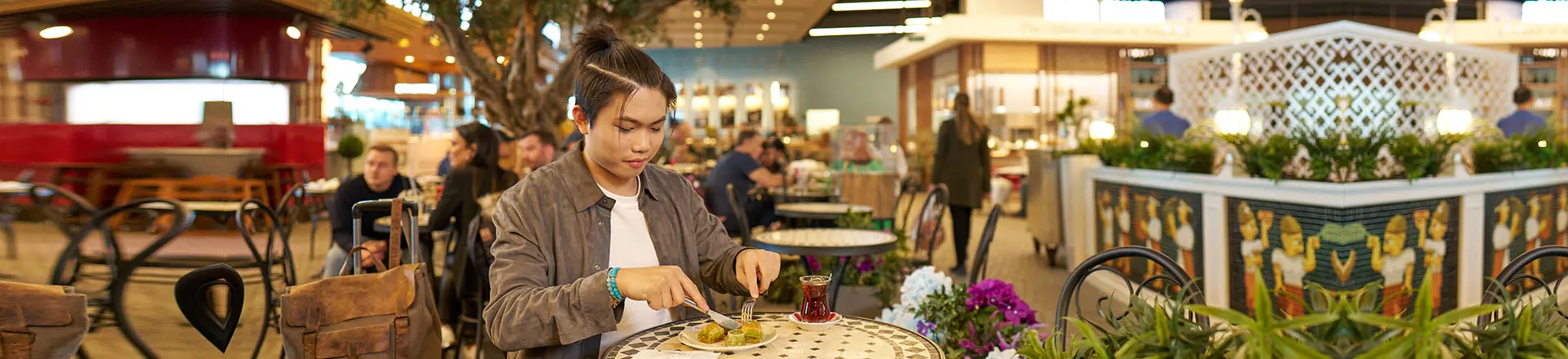 a passenger eating her food at the istanbul airport